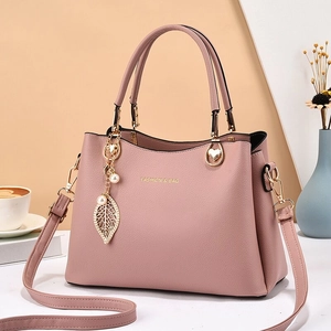 Pink faux leather tote bag with leaf pearl pendant and gold hardware for women