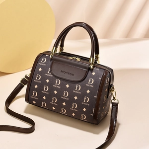 Classic dark brown Boston handbag with MQCKDE monogram pattern and gold metal hardware
