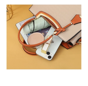 Top-down detail showing large capacity of the beige crocodile pattern tote with everyday essentials