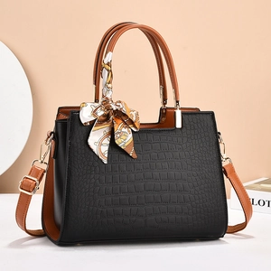 Black and brown faux crocodile leather tote bag with printed scarf on the handle