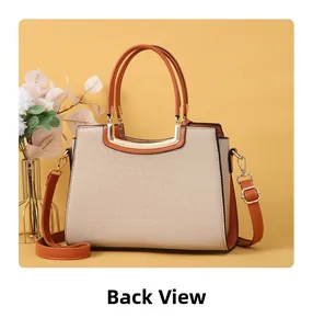 Back view detail of beige and orange crocodile pattern handbag with golden hardware