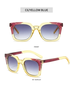 Detail view of retro square sunglasses with yellow burgundy frame and blue gradient lenses