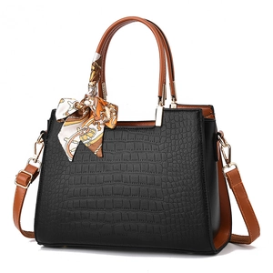 Black crocodile embossed handbag with brown handles and elegant horse print silk scarf
