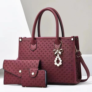 Detailed set of burgundy woven tote bag with matching wallet and charm accessories