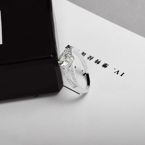 Detailed view of large round brilliant-cut diamond ring with split shank pave band
