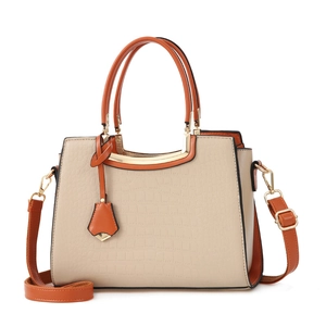 Chic beige crocodile pattern handbag with orange contrast handles and gold hardware