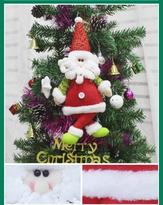 Detail of plush Santa Claus ornament hanging on a Christmas tree with felt fabric textures