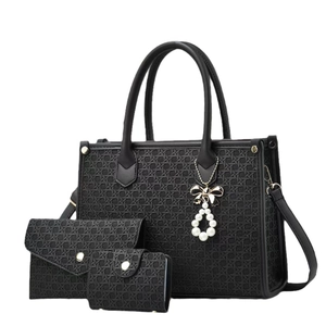 Classic black three-piece tote bag set with woven texture and pearl bow pendant