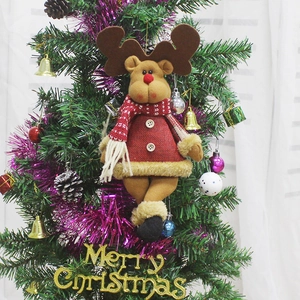 Hanging reindeer Christmas plush ornament with red burlap outfit on a decorated tree
