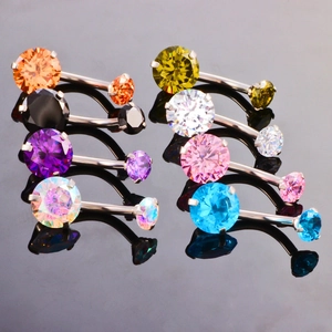 Detailed view of eight stainless steel belly rings with multicolored cubic zirconia stones