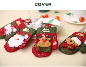 Close-up of festive Christmas cutlery holders in glove shapes with 3D cartoon characters