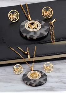 Detail of gold-plated stainless steel necklace with leopard print inlay and rhinestones