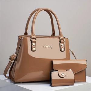 Three-piece women's set with glossy faux leather tote, envelope clutch, and card holder