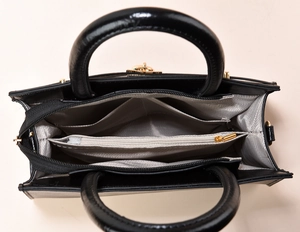 Internal view of black leather tote bag with grey herringbone lining and multi compartments