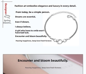 Close-up of S925 sterling silver cat and heart charms on a flat snake bone bracelet