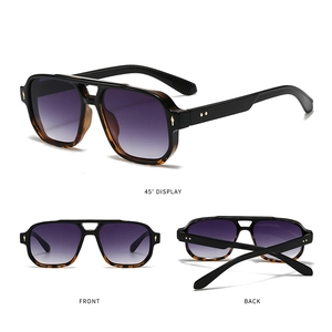 Detail view of square double-bridge sunglasses with tortoise frame and purple gradient lens