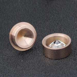 Macro detail of rose gold screw back earrings with clear round cubic zirconia stones