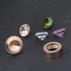 Macro detail of rose gold screw-on earring bases with colorful cubic zirconia stones
