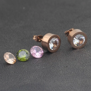 Detail view of rose gold stainless steel stud earrings with interchangeable zircons