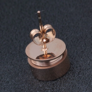 Macro detail of the rose gold stainless steel earring back showing butterfly clasp