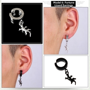 Detail of gecko lizard pendant earrings in black and silver steel for men and women
