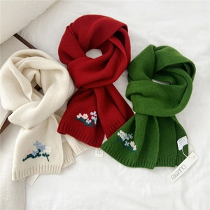 Knitted wool scarves in red, white and green with delicate floral embroidery details