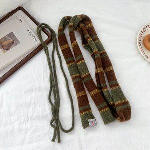 Close-up of striped knit scarf texture showing the premium warm wool blend material
