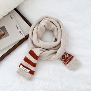 Detailed view of 100% pure wool striped knit scarf with Nordic jacquard texture
