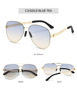 Detail view of aviator sunglasses with gold double bridge and blue gradient lenses