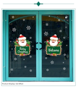 Close-up of Santa Claus window stickers with Merry Christmas and Welcome signs