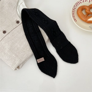 Detailed macro view of 100% wool knitted scarf showing soft texture and premium craftsmanship