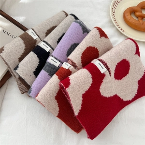 Close-up of wool scarves featuring vibrant floral patterns in diverse color options