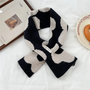 Detail of knitted 100% wool scarf showing high-quality black and white textured knit pattern