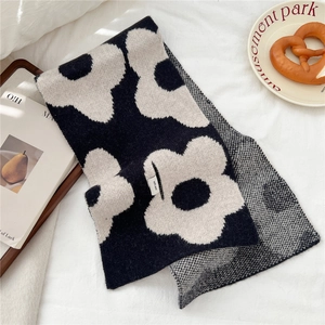 Detail showing the 100% wool material label and the classic floral knit pattern