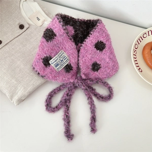 Close-up of pink polka dot knit scarf with soft plush texture and stylish bow tie detail