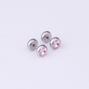 Macro shot of a pink crystal stud earring with a silver stainless steel screw back