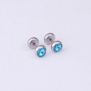 Close-up of silver steel dumbbell earrings with sky blue crystal studs and backings