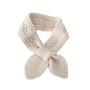 Knitted wool scarf in cream white featuring elegant cross-knot design and ribbed texture