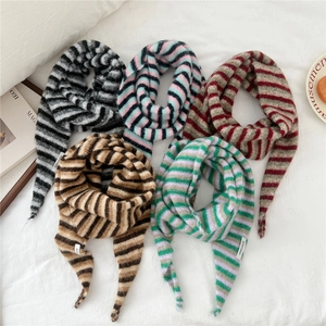 Soft striped knit triangular scarves in five colors shown in a lifestyle flat lay