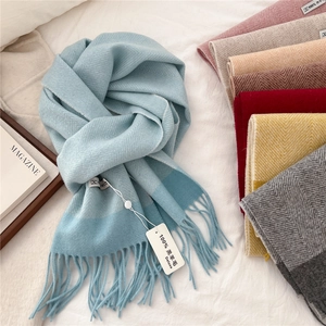 Detailed view of 100% lambswool scarf with herringbone pattern and fringe edges