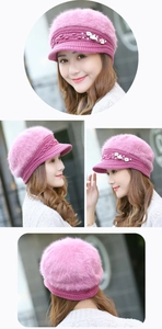 Detailed view of women's pink winter knit hat with floral pearls and rabbit fur texture