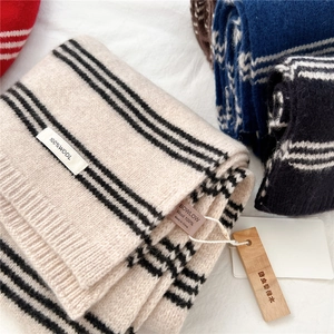 Detail of 100% wool striped scarf with functional cedar wood anti-moth tag