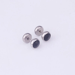 Macro shot of silver stainless steel dumbbell earrings with black round crystal inlay