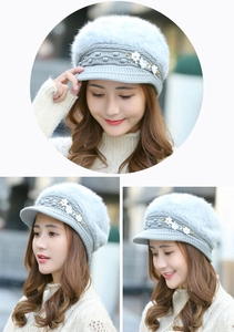 Detailed close-up of grey knit rabbit fur hat with 3D white flower and gold bead accents