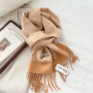 Close-up of 100% lamb wool herringbone scarf with fringe details and woven texture