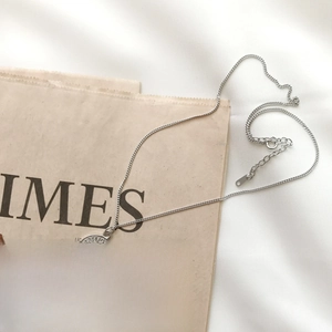 Macro shot of 925 silver coin pendant on newspaper with detailed female engraving