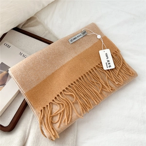 Detail of 100% lamb wool scarf with twill weave texture and soft tassel edge