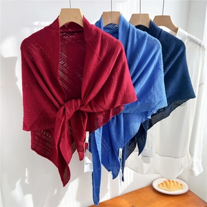 Lightweight knitted triangular shawl in red, blue, and navy with geometric patterns