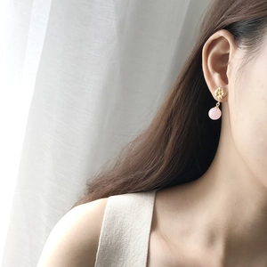 925 silver flower stud earrings with pink shell pearl dangles on a model's ear