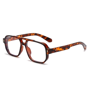 Square double bridge tortoiseshell glasses frame with metal rivet details in side view